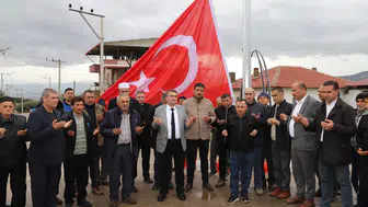 Saruhanlı'da Türk bayrağı dualar eşliğinde göndere çekildi